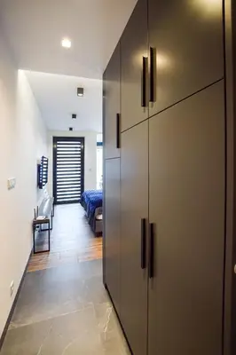 a room with a closet and a bedroom with a bed at In City Apartments Rajska 3 in Kraków