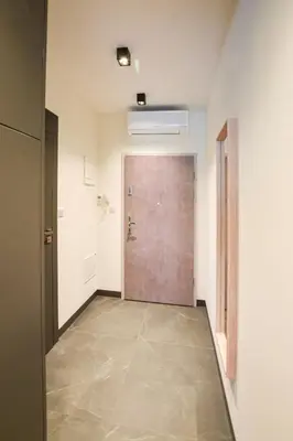 an empty hallway with a door and a room at In City Apartments Rajska 3 in Kraków
