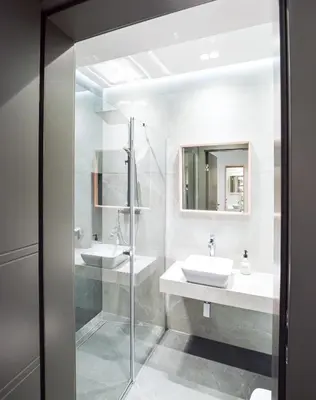 a bathroom with two sinks and a shower at In City Apartments Rajska 3 in Kraków
