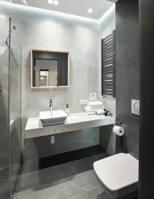 a bathroom with a sink and a toilet at In City Apartments Rajska 3 in Kraków