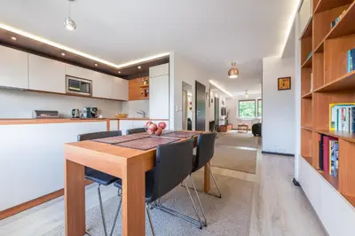 a kitchen and dining room with a wooden table and chairs at do parku zdrojowego 1 krok in Rabka
