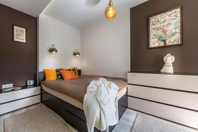 a bedroom with a bed and a dresser in it at do parku zdrojowego 1 krok in Rabka