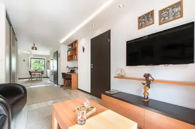 a living room with a large flat screen tv on a wall at do parku zdrojowego 1 krok in Rabka