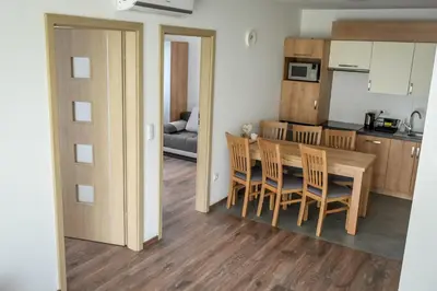 a kitchen and dining room with a table and chairs at Słoneczne Wzgórze Zator in Zator