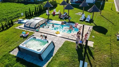 an overhead view of a swimming pool with people in it at Słoneczne Wzgórze Zator in Zator