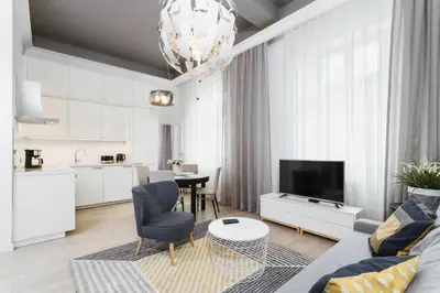 a living room with a couch and a table at Apartment Krakow Arianska by Renters Prestige in Kraków