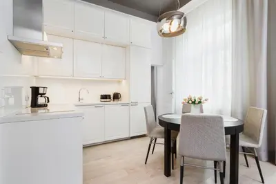 a kitchen and dining room with a table and chairs at Apartment Krakow Arianska by Renters Prestige in Kraków