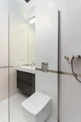 a white bathroom with a toilet and a sink at Apartment Krakow Arianska by Renters Prestige in Kraków