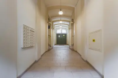 an empty hallway with a green door in a building at Apartment Krakow Arianska by Renters Prestige in Kraków