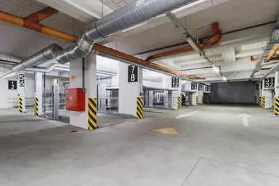 an empty parking lot in a parking garage at Apartment Krakow Arianska by Renters Prestige in Kraków