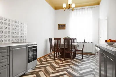 a kitchen with a table and chairs and a dining room at Top Location Apartments Topolowa Street in Kraków