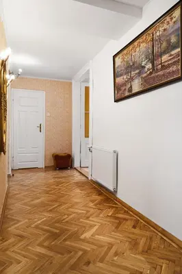 a room with a wooden floor and a painting on the wall at Top Location Apartments Topolowa Street in Kraków