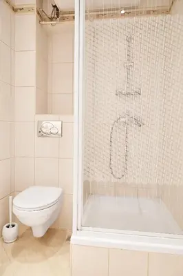 a bathroom with a toilet and a bath tub at Top Location Apartments Topolowa Street in Kraków