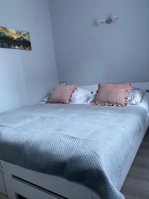 a white bed with two pillows on top of it at Pokoje u Jasia i Małgosi in Skawa