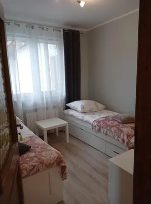 a small bedroom with two beds and a window at Pokoje u Jasia i Małgosi in Skawa