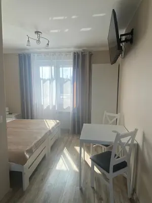 a bedroom with a bed and a table and chair at Pokoje u Jasia i Małgosi in Skawa