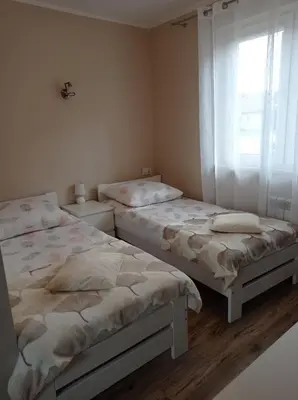 two twin beds in a room with a window at Pokoje u Jasia i Małgosi in Skawa