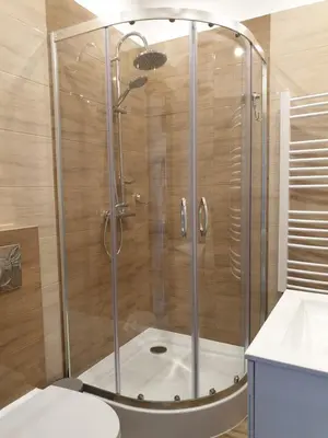 a shower with a glass door in a bathroom at Pokoje u Jasia i Małgosi in Skawa