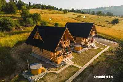 an overhead view of a log cabin in a field at Domki Gorce Klikuszowa Sauna Jacuzzi in Klikuszowa