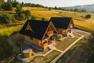 an overhead view of a log cabin in a field at Domki Gorce Klikuszowa Sauna Jacuzzi in Klikuszowa