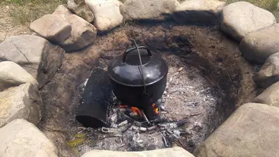 a pot on top of a fire with rocks at Dom w Beskidach in Stryszawa