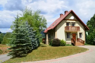 a house with a christmas tree in front of it at Dom w Beskidach in Stryszawa