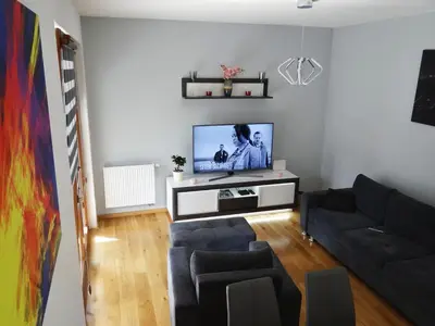 a living room with a couch and a flat screen tv at Beautiful City Centre Apartament in Kraków