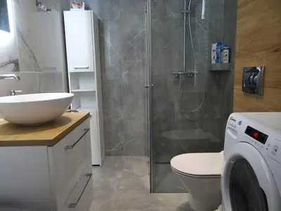 a bathroom with a shower and a toilet and a sink at Beautiful City Centre Apartament in Kraków