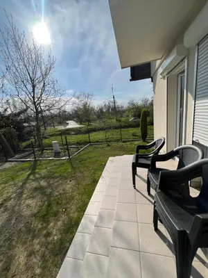 a porch with two benches and a view of a field at Dom nad Skawą - Zator 5km in Grodzisko