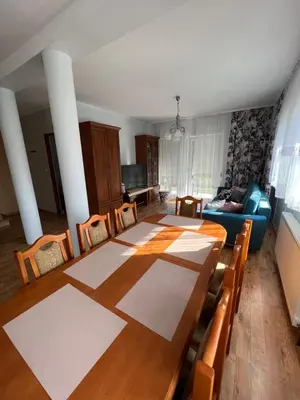 a living room with a table and a couch at Dom nad Skawą - Zator 5km in Grodzisko