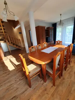 a dining room with a wooden table and chairs at Dom nad Skawą - Zator 5km in Grodzisko