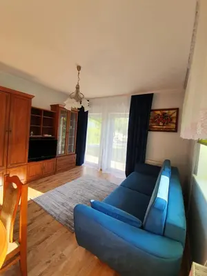 a living room with a blue couch in a room at Dom nad Skawą - Zator 5km in Grodzisko