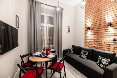 a living room with a table and a couch at Dietla 32 Residence - ideal location in the heart of Krakow, between Main Square and Kazimierz District in Kraków