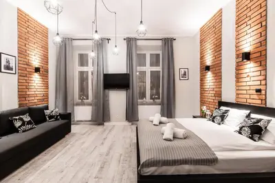 a living room with a large bed and a couch at Dietla 32 Residence - ideal location in the heart of Krakow, between Main Square and Kazimierz District in Kraków