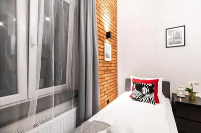 a small bedroom with a bed and a window at Dietla 32 Residence - ideal location in the heart of Krakow, between Main Square and Kazimierz District in Kraków