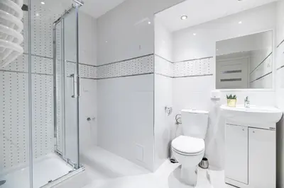 a white bathroom with a toilet and a shower at Dietla 32 Residence - ideal location in the heart of Krakow, between Main Square and Kazimierz District in Kraków