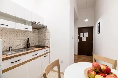 a kitchen with a table with a bowl of apples on it at Dietla 32 Residence - ideal location in the heart of Krakow, between Main Square and Kazimierz District in Kraków