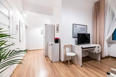 a white office with a desk with a computer on it at Dietla 32 Residence - ideal location in the heart of Krakow, between Main Square and Kazimierz District in Kraków