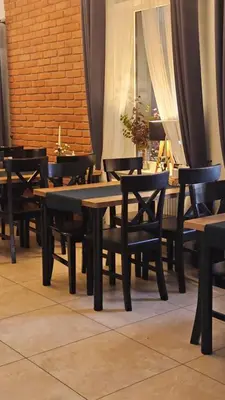 a group of tables and chairs in a restaurant at Gościniec pod Lilijką in Podzamcze