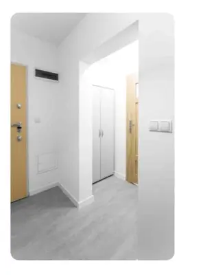 an empty room with white walls and white doors at Room Tour Rakowicka 14a in Kraków