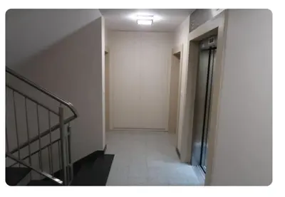 a hallway with a staircase in a building at Room Tour Rakowicka 14a in Kraków
