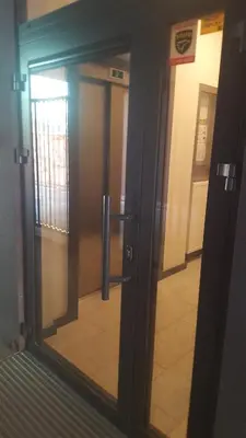 an elevator door with a reflection of a hallway at Room Tour Rakowicka 14a in Kraków