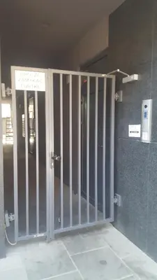 a metal gate in a building with a door at Room Tour Rakowicka 14a in Kraków