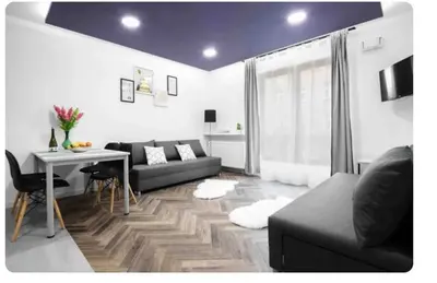 a living room with a couch and a table at Room Tour Rakowicka 14a in Kraków