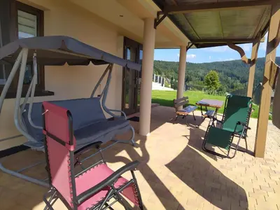 a group of chairs sitting on a patio at Cicha Chata Kudłacze in Pcim
