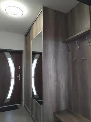 a dressing room with wooden walls and a mirror at Cicha Chata Kudłacze in Pcim