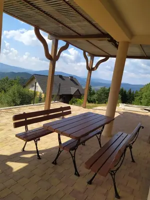two benches sitting under a gazebo on a patio at Cicha Chata Kudłacze in Pcim