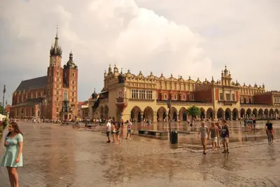 a group of people standing in front of a large building at Art Pop in Cracow in Kraków