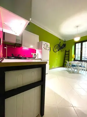 a kitchen with green walls and a stove top oven at Art Pop in Cracow in Kraków