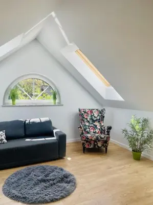 a living room with a couch and a chair at Zakątek Solny in Bochnia